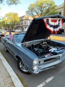 historic car with flag on open hood