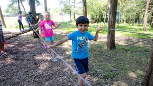 kids playing on balance rope outdoors