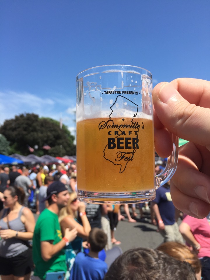 small beer stein with crowd in background