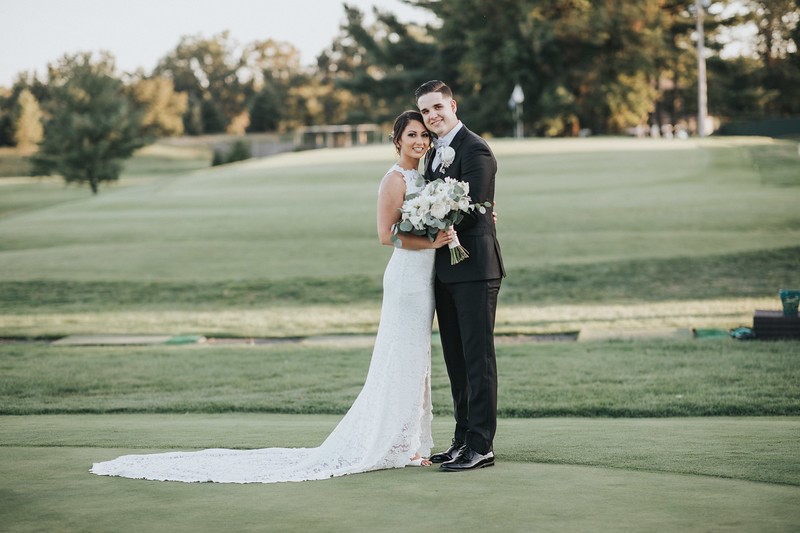 couple wedding dressed on golf course