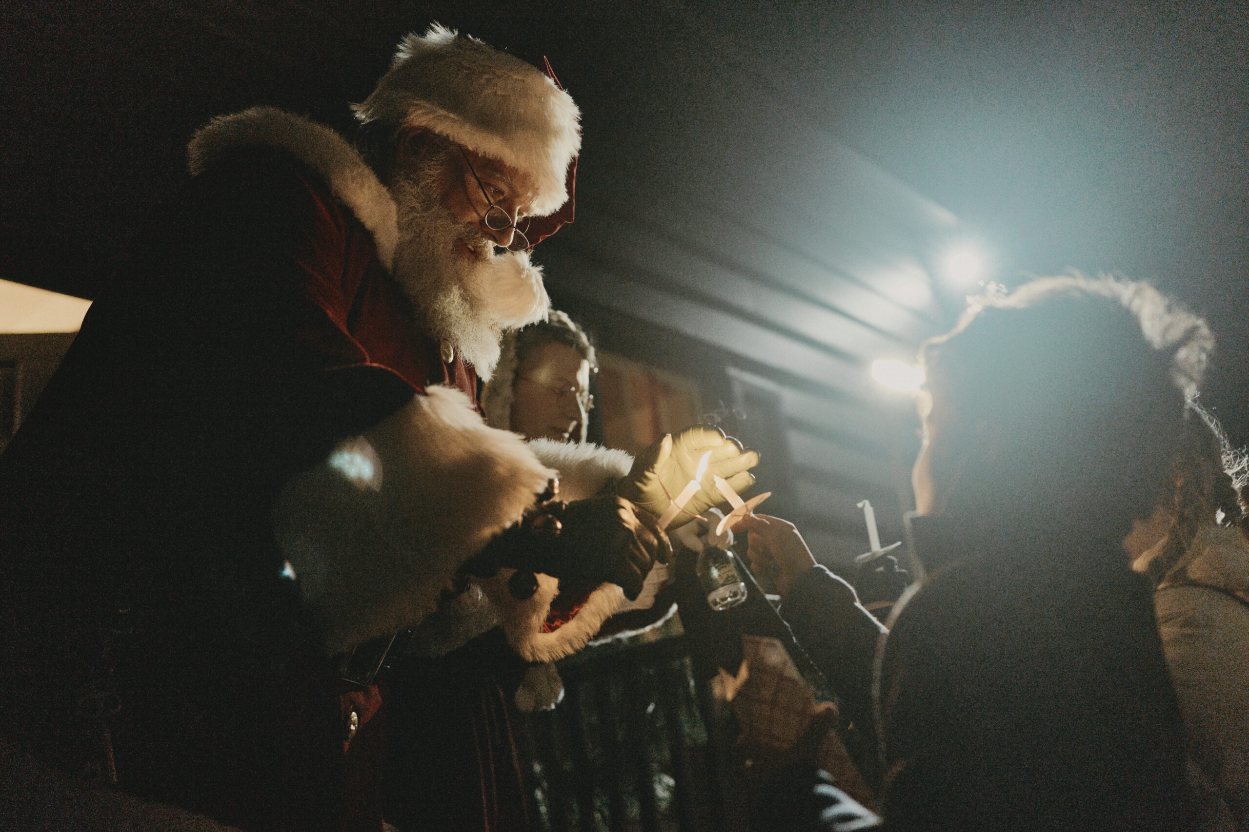 santa handing item to child